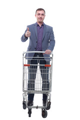 A full length portrait of a man pushing an empty shopping cart