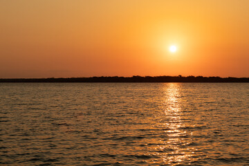 Sunrise at Bacalar lagoon , the sun light is reflect on the lagoon water , Rivera maya , Mexico