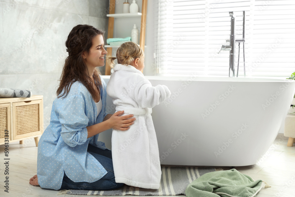 Poster Mother with her daughter after bath at home