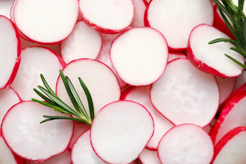 Slices of fresh radish and rosemary as background