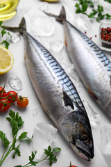 Raw mackerel, tomatoes and parsley on white table, above view