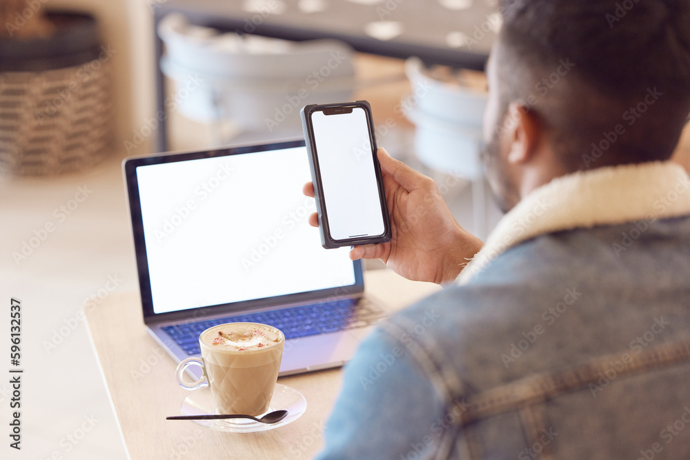 Poster Setting my own pace of work. a man using his smartphone and laptop to work in a coffee shop while enjoying a cup of coffee.