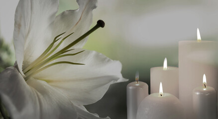Funeral. White lily and burning candles on blurred background, banner design
