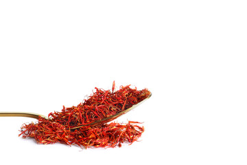 Fototapeta premium Spoon with pile of saffron on white background
