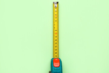 Measuring tape on green background
