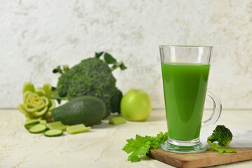 Glass of tasty green juice on grunge table