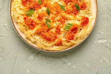 Plate of tasty Italian pasta with Parmesan cheese on light background
