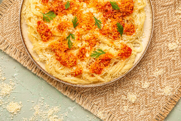 Plate of tasty Italian pasta with Parmesan cheese on table, closeup