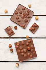 Sweet tasty chocolate with nuts on  light wooden background