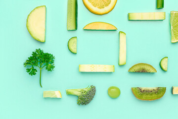 Composition with different fresh fruits and vegetables on green background