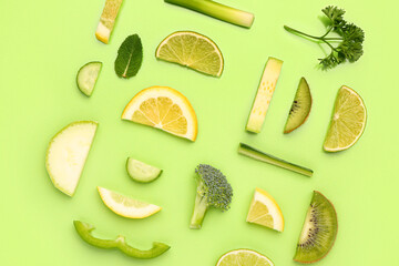 Composition with different fresh fruits and vegetables on green background