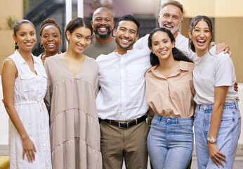Winning, collectively. Portrait of a group of businesspeople casually posing for a photo in a modern office.