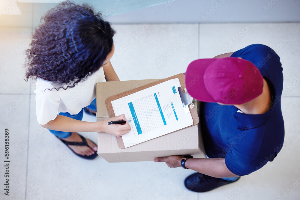 Poster its all yours once you sign for it. high angle shot of a customer signing for her delivery from the 