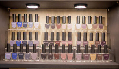 Bottles of colorful nail polish, and nail art colors at the nail shop and beauty salon.