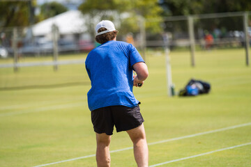 Amateur playing tennis at a tournament and match on grass in Europe 