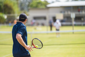 Amateur Tennis player, playing tennis at a tournament and match on grass in Europe