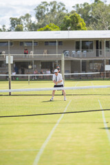 Amateur playing tennis at a tournament and match on grass in Europe 