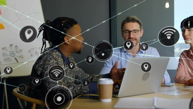Animation of network of digital icons over diverse colleagues discussing together at office