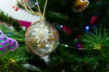 Decorating the Christmas tree with glass toys