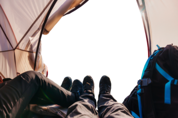 Couple traveler relaxing inside a tent on summer vacation with empty background