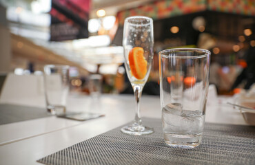 Alcohol at the bar evokes luxury, celebration, and indulgence. Cocktails and champagne symbolize sophistication and socializing, but can also represent excess and addiction