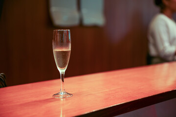 Alcohol at the bar evokes luxury, celebration, and indulgence. Cocktails and champagne symbolize sophistication and socializing, but can also represent excess and addiction