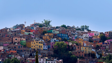 Fototapeta na wymiar Colorful hillside houses and balconies in the upper part of Guanajuato.
