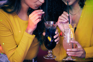 Grab your bestie for a great night out. two unrecognisable women having cocktails on a fun night out.