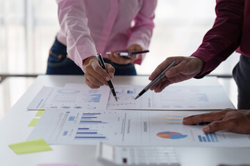 Close up of Diverse colleagues gather brainstorm discuss financial statistics at office meeting. finance, teamwork, Big data Graphs Charts concept