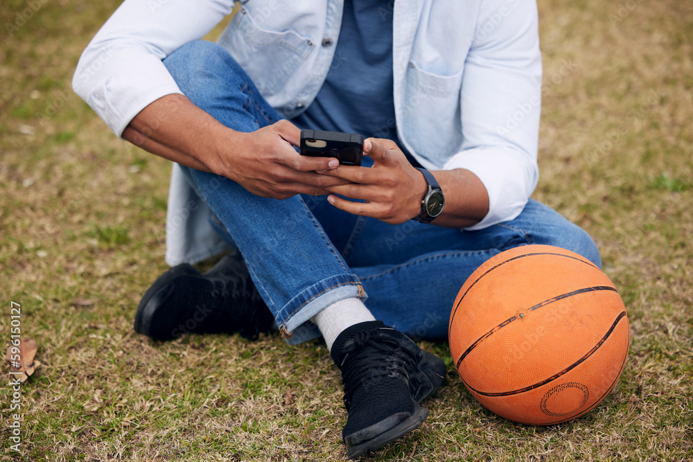 Poster basketball and beats are all you really need. an unrecognisable man using a smartphone outside at co