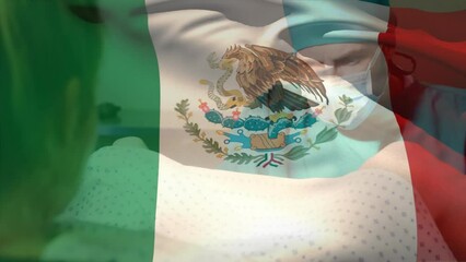 Animation of waving mexico flag over caucasian male surgeon operating pregnant woman during delivery - Powered by Adobe
