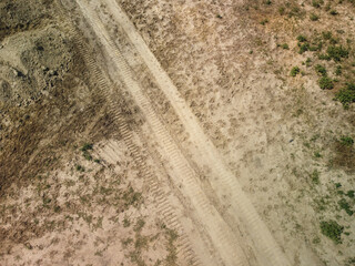 Scenic view on the gravel road with stones and vegetation on roadsides