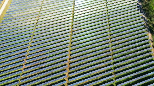 Flying over  solar panels with the sun reflected on them.Portugal