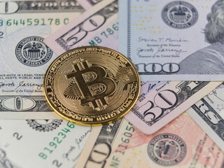 bitcoin coin and Us dollar bills