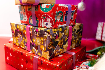 Fototapeta na wymiar Three New Year's gifts are wrapped in bright paper