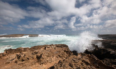 Fototapeta na wymiar Sunny day with storm waves crashing into Laie Point coastline at Kaawa on the North Shore of Oahu Hawaii United States