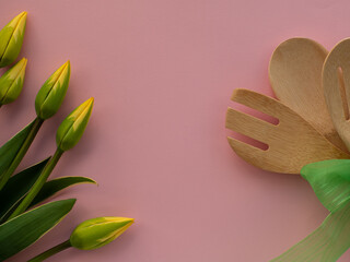 Tulips flowers with kitchen tools on background with copy space