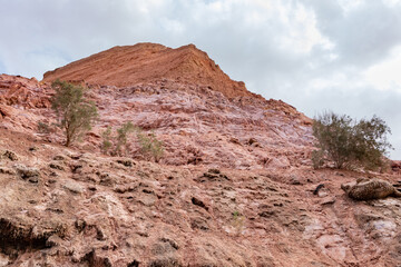 Red  mountains containing a lot of copper surround the deep blue Hidden Lake near the Timna...