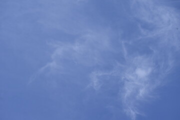 clear sky with white clouds of light mist