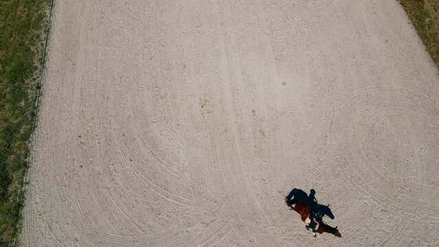 Seen from above a girl riding a lusitano horse in the ring,Portugal