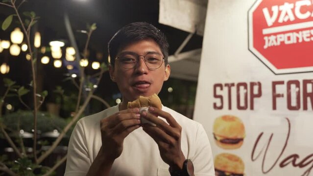 Expressing The Satisfaction Of A Man Eating The Hamburger Deliciously. static