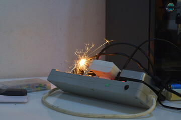 electrical plug sparking and burning Caused by a short circuit, concept, danger from using...