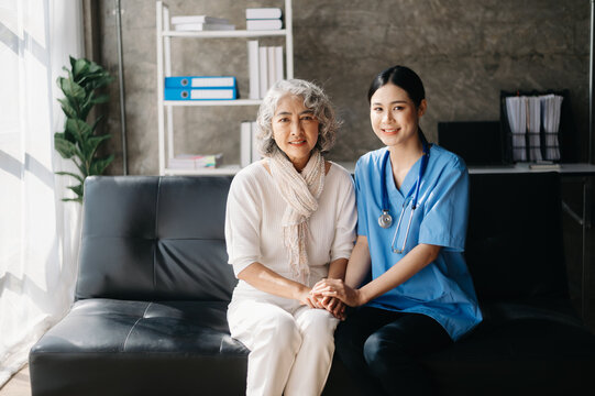 Kind nurse together with elderly woman in the hospital's