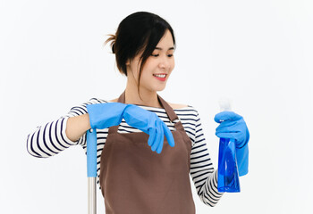 Happy young woman wearing blue rubber gloves for hands protection , holding mop and spray bottle , smiling at camera while cleaning house isolated over white background