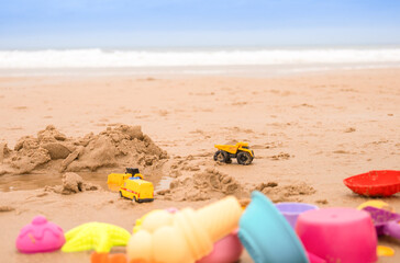 Colorful toys on the beach by the sea