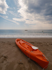 a beautiful red canoe on the beach