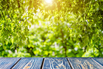 Wooden table and blurred green natural background.
