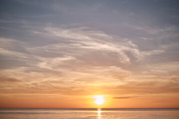 Naklejka na ściany i meble Orange sky at sunset at sea