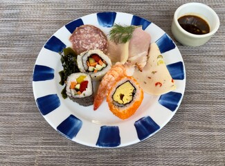 Cold dish with sushi and ham