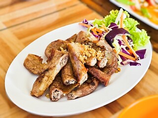 Grilled Pork Intestines with fried garlic and vegetable salad.